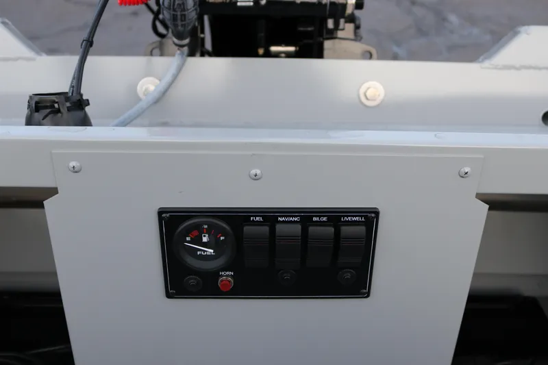 Slide: The Image of Control panel of 2026 Smoker Craft Sportsman 1660 boat with fuel gauge and switches. - 18