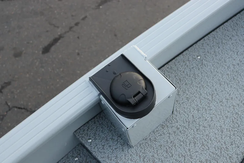 Slide: The Image of 2026 Smoker Craft Sportsman 1660 boat detail, featuring a black electrical outlet on a gray surface. - 19