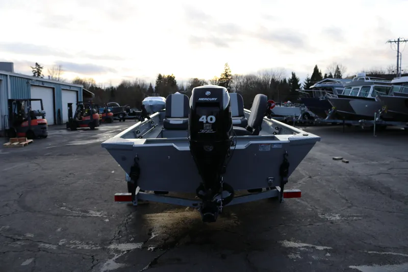 Slide: The Image of 2026 Smoker Craft Sportsman 1660 boat with Mercury 40 engine in a parking lot. - 4