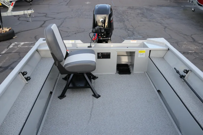 Slide: The Image of 2026 Smoker Craft Sportsman 1660 boat interior with seating and motor, showcasing spacious design. - 6