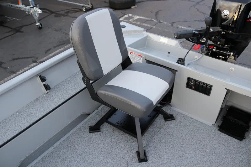 Slide: The Image of 2026 Smoker Craft Sportsman 1660 boat interior with gray seating and control panel. - 7