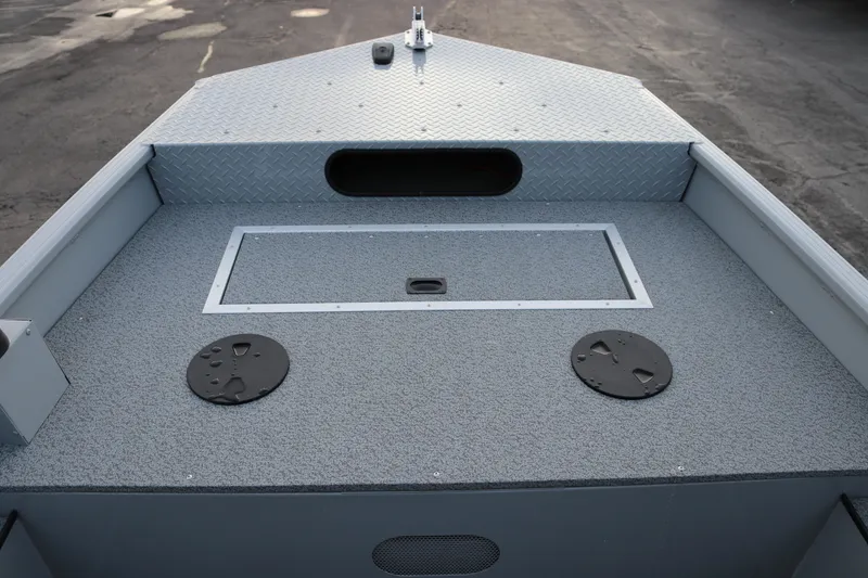 Slide: The Image of 2026 Smoker Craft Sportsman 1660 boat deck with storage compartments and non-slip surface. - 9