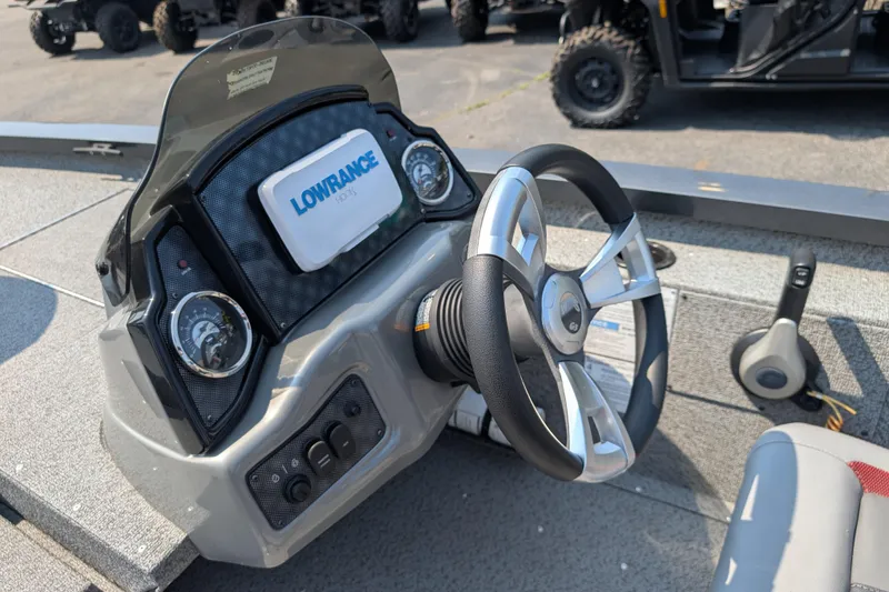 Slide: The Image of 2022 G3 Sportsman 1710 boat dashboard with steering wheel and Lowrance GPS system. - 5