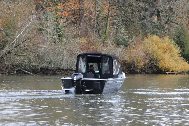 Slide: The Image of 2026 Alumaweld Stryker X202 boat cruising on a scenic river with autumn foliage. - 3