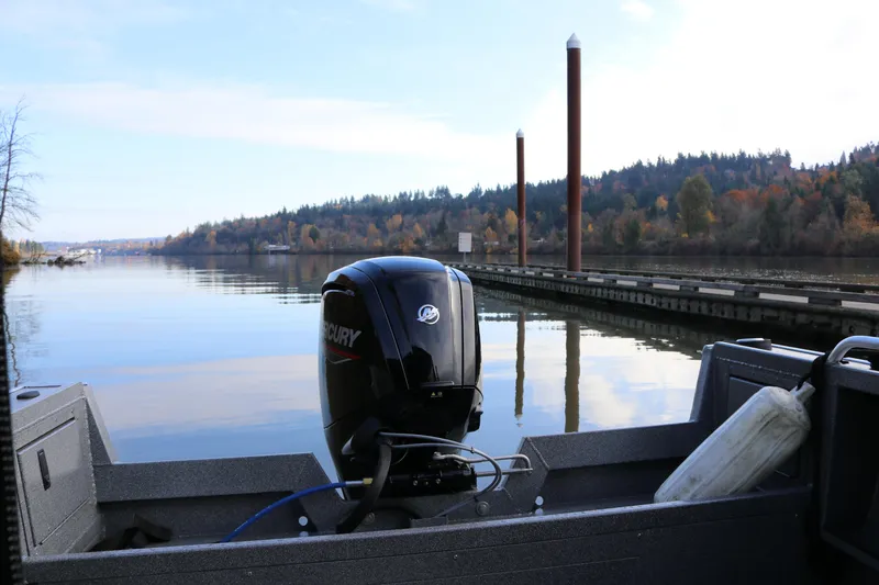 Slide: The Image of 2026 Alumaweld Stryker X202 boat with Mercury engine on a serene lake. - 5