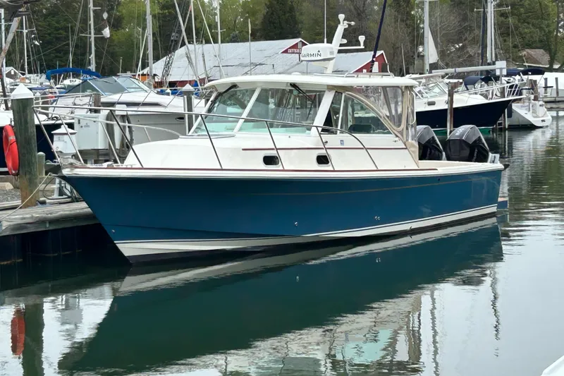 The Image of 2020 Hunt Yachts Surfhunter 32 cruising on calm waters, showcasing sleek design and powerful engines. - 0