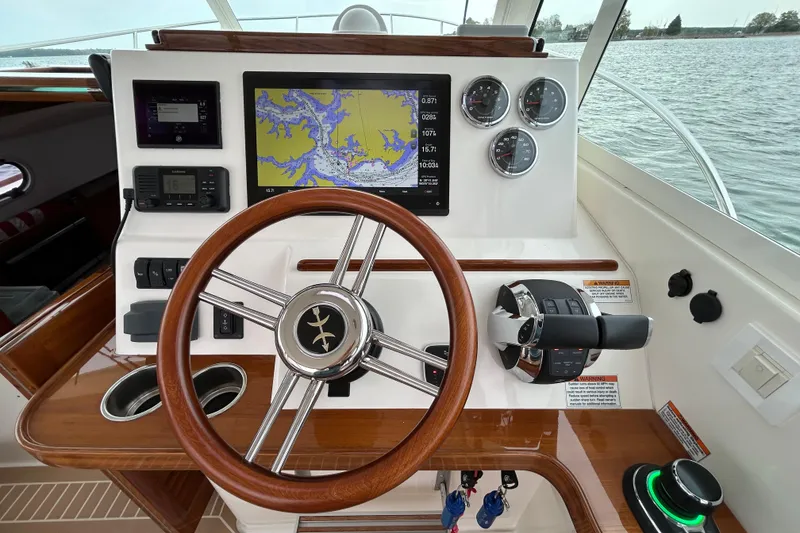 Slide: The Image of Control panel of a 2020 Hunt Yachts Surfhunter 32 boat with throttle and warning labels. - 11
