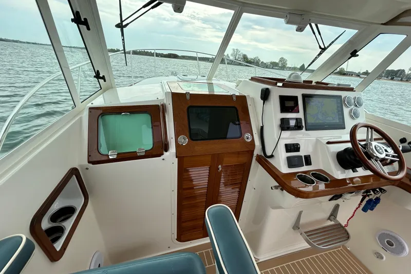 Slide: The Image of Helm of 2020 Hunt Yachts Surfhunter 32 with navigation display and controls. - 13