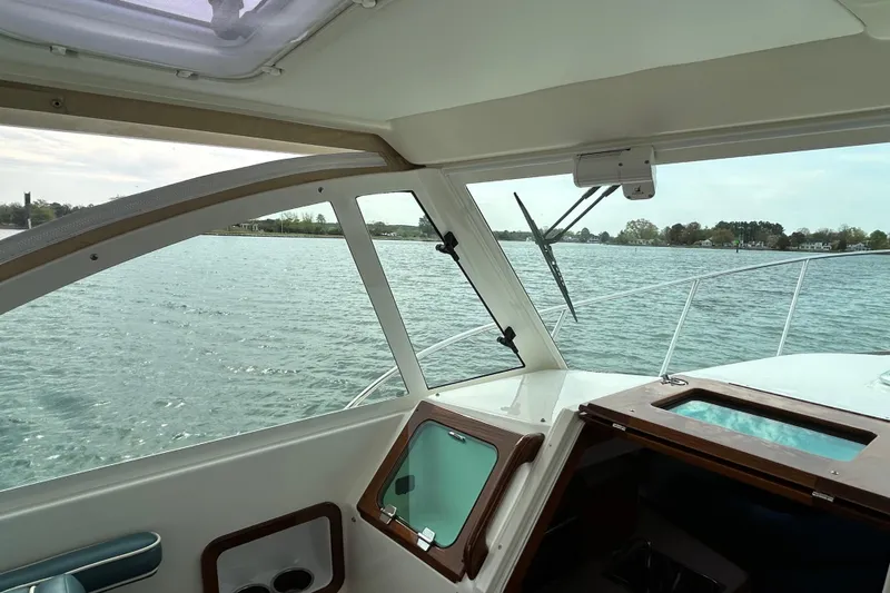 Slide: The Image of 2020 Hunt Yachts Surfhunter 32 helm with navigation equipment and wooden accents. - 15