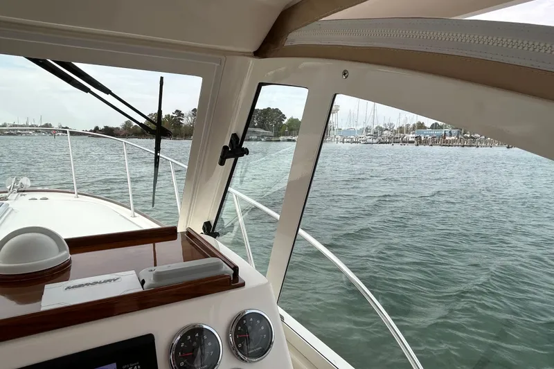 Slide: The Image of 2020 Hunt Yachts Surfhunter 32 cockpit with navigation equipment and wooden interior details. - 16