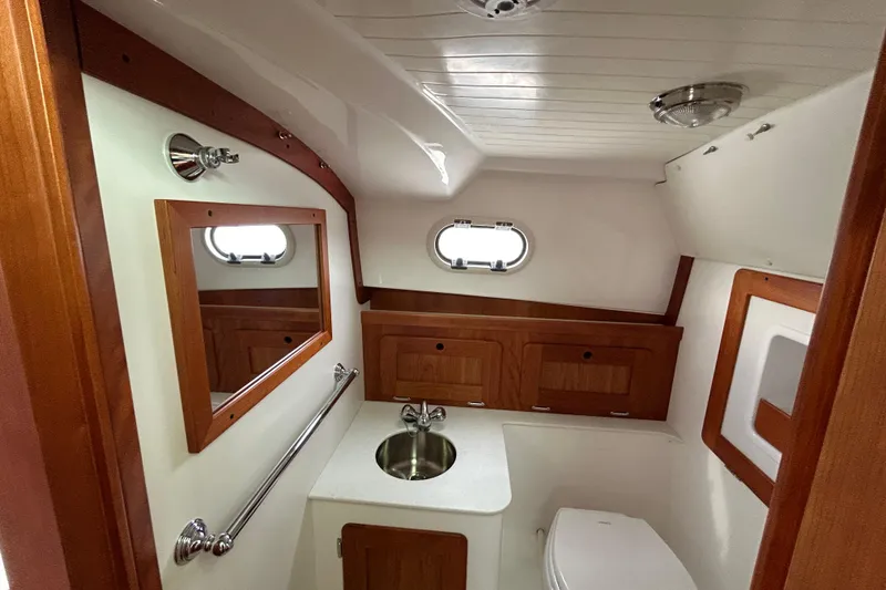Slide: The Image of 2020 Hunt Yachts Surfhunter 32 boat interior with clear enclosure on calm water. - 23