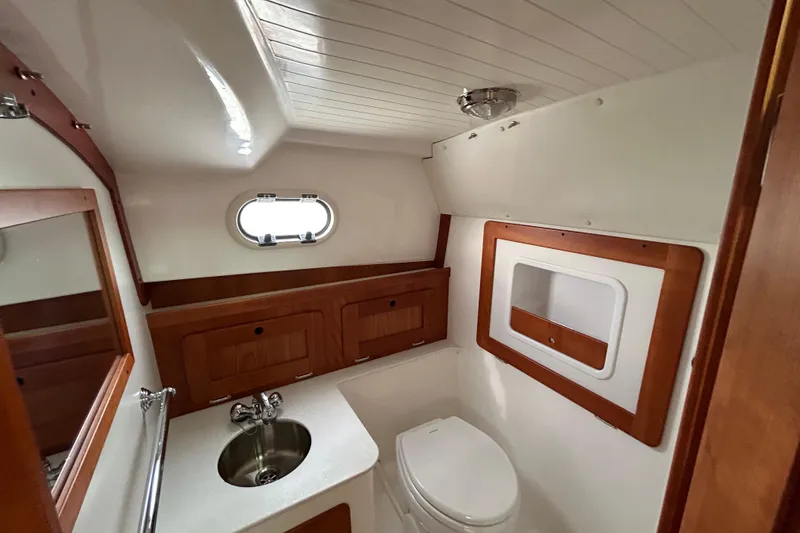 Slide: The Image of 2020 Hunt Yachts Surfhunter 32 on water, showcasing interior seating and helm. - 24