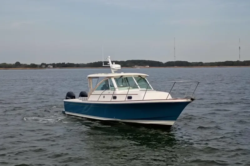 Slide: The Image of 2020 Hunt Yachts Surfhunter 32 cruising on calm waters under a clear sky. - 28