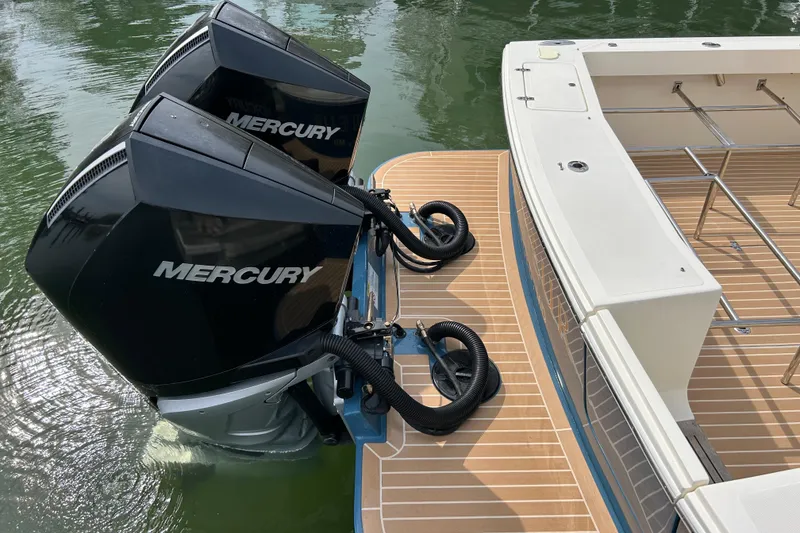 Slide: The Image of 2020 Hunt Yachts Surfhunter 32 boat docked by the water, featuring a sleek blue hull. - 5