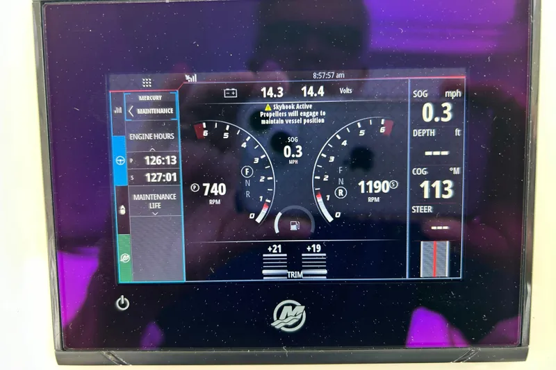 Slide: The Image of Twin Mercury outboard engines on a 2020 Hunt Yachts Surfhunter 32, docked on water. - 7