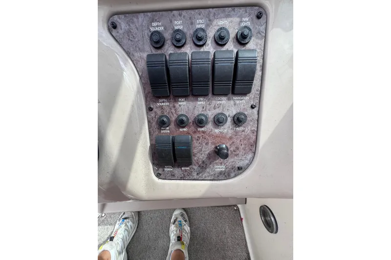 Slide: The Image of 1999 Sea Ray 270 Sundancer Special Edition control panel with switches and buttons. - 10