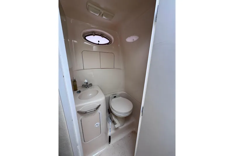 Slide: The Image of 1999 Sea Ray 270 Sundancer Special Edition boat bathroom with sink and toilet. - 13