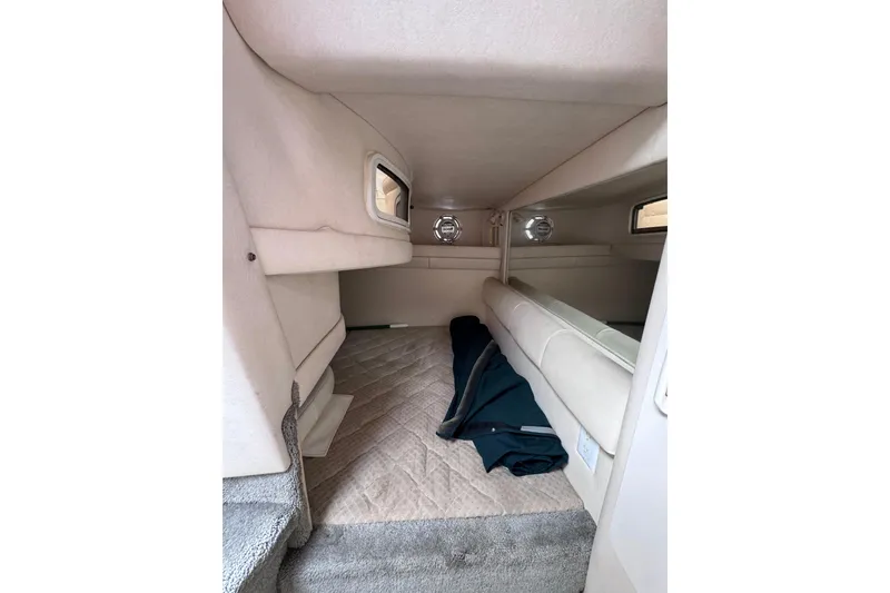 Slide: The Image of 1999 Sea Ray 270 Sundancer Special Edition cabin interior with beige upholstery. - 14