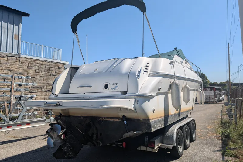 Slide: The Image of 1999 Sea Ray 270 Sundancer Special Edition boat on trailer, outdoor storage. - 4