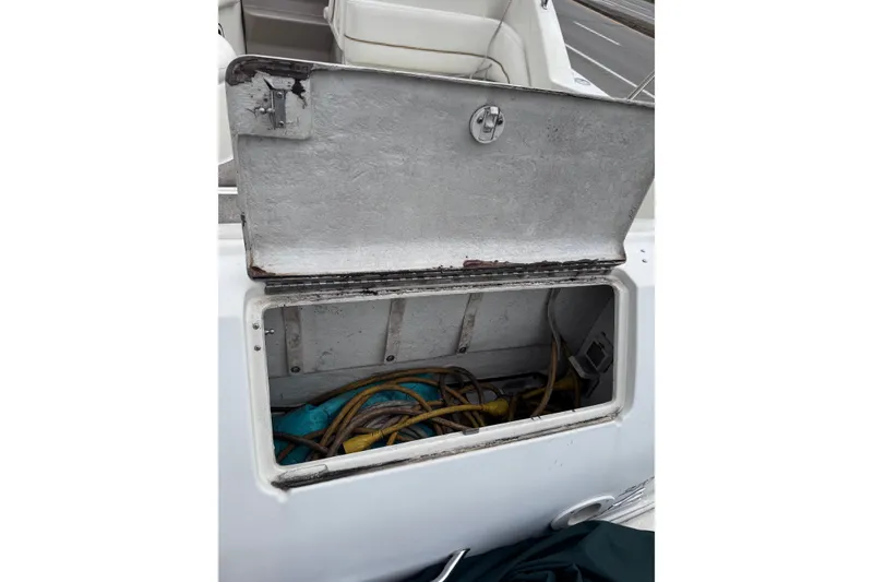 Slide: The Image of Open storage compartment on 1999 Sea Ray 270 Sundancer Special Edition boat. - 7