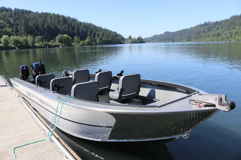 Slide: The Image of 2026 Alumaweld Adventurer 20 boat docked on a serene lake with forested background. - 3