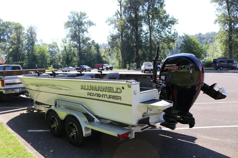 Slide: The Image of 2026 Alumaweld Adventurer 20 boat on trailer with Mercury Pro XS engine in a parking lot. - 4