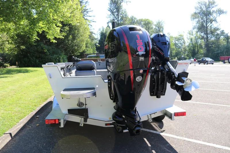Slide: The Image of 2026 Alumaweld Adventurer 20 boat with powerful 150 HP outboard motor in a parking lot. - 5