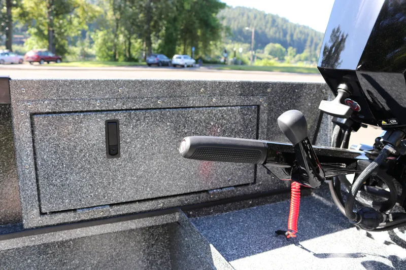 Slide: The Image of 2026 Alumaweld Adventurer 20 boat interior with motor controls and storage compartment. - 6