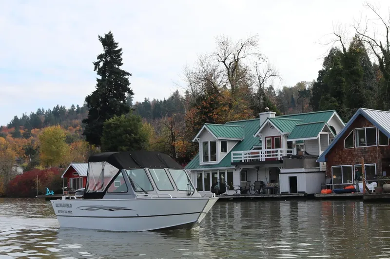 The Image of 2026 Alumaweld Stryker 202 boat on a scenic lake near waterfront homes. - 0