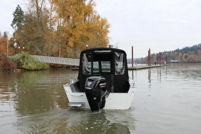 Slide: The Image of 2026 Alumaweld Stryker 202 boat on a calm lake near a dock in autumn. - 2
