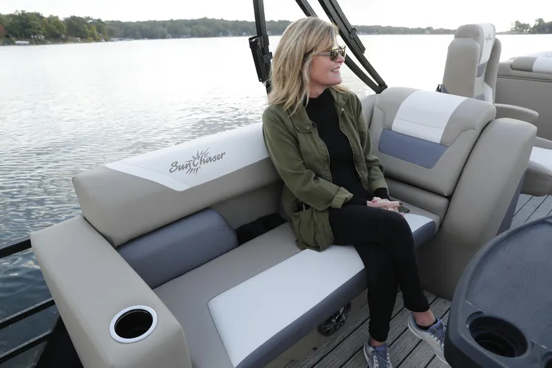 Slide: The Image of Woman relaxing on a 2026 SunChaser Eclipse 25 LR DH pontoon boat by a lake. - 4
