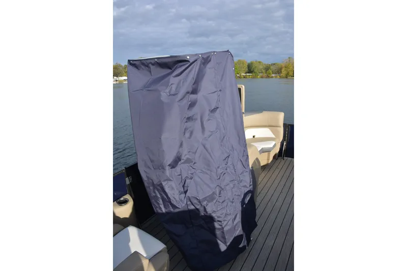 Slide: The Image of SunChaser Eclipse 25 LR DH 2026 boat with privacy curtain on deck, lake view. - 7