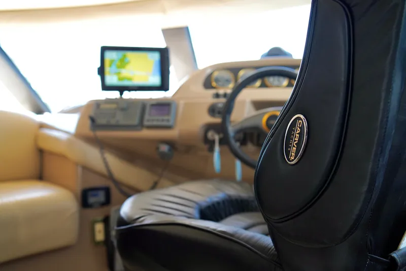 Slide: The Image of Interior of 1999 Carver 450 Voyager Pilothouse with navigation equipment and leather seating. - 19
