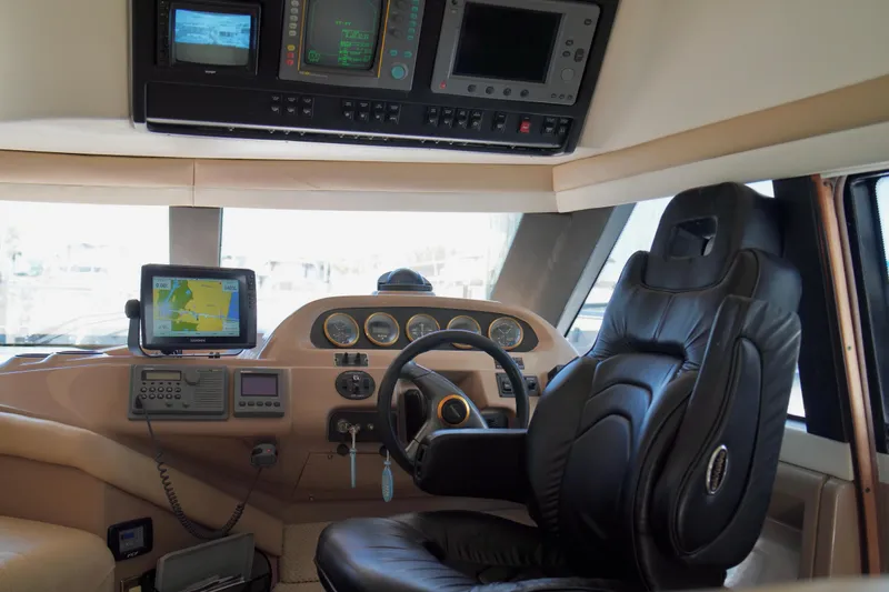 Slide: The Image of 1999 Carver 450 Voyager Pilothouse interior with navigation equipment and captain's chair. - 22