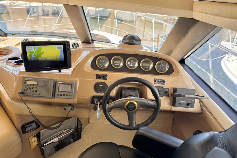 Slide: The Image of 1999 Carver 450 Voyager Pilothouse helm with navigation equipment and steering wheel. - 23