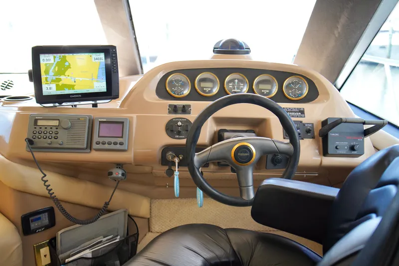 Slide: The Image of 1999 Carver 450 Voyager Pilothouse helm with navigation equipment and steering wheel. - 24