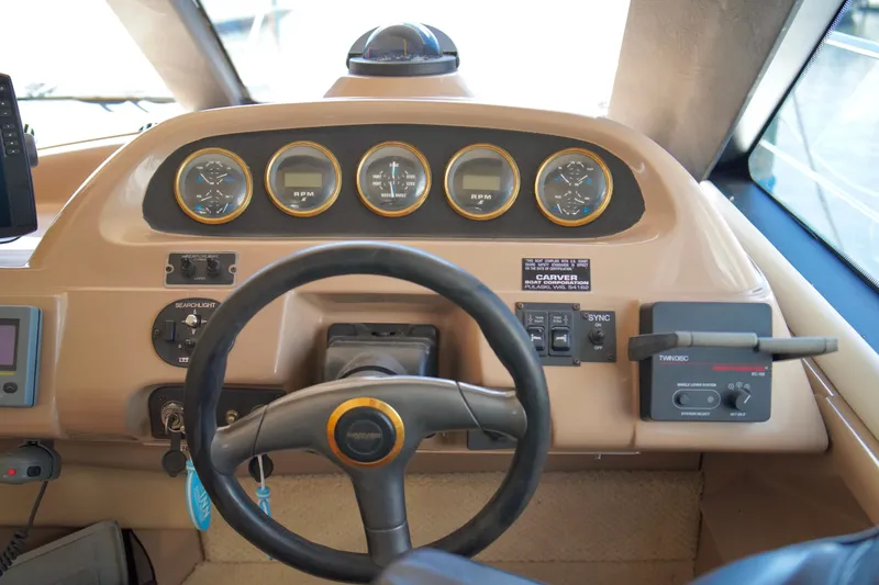 Slide: The Image of 1999 Carver 450 Voyager Pilothouse helm with steering wheel and instrument panel. - 25