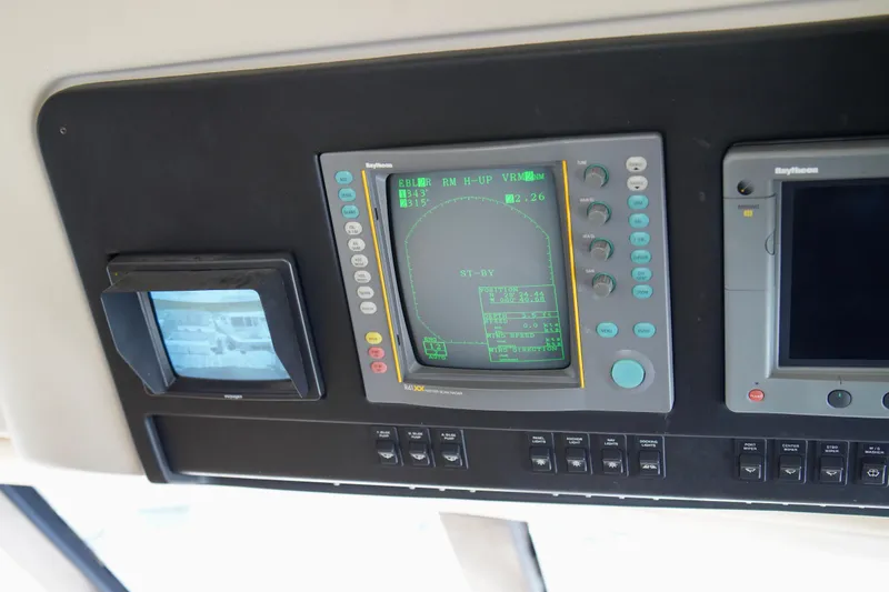 Slide: The Image of Control panel of 1999 Carver 450 Voyager Pilothouse with navigation and radar displays. - 27