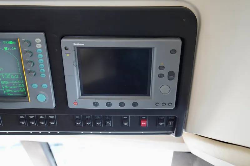 Slide: The Image of Control panel of a 1999 Carver 450 Voyager Pilothouse with navigation equipment. - 28