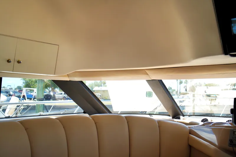 Slide: The Image of Interior view of 1999 Carver 450 Voyager Pilothouse, featuring beige seating and large windows. - 29