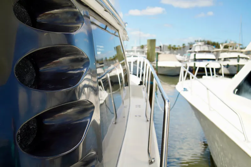 Slide: The Image of 1999 Carver 450 Voyager Pilothouse docked at marina, side view with railings. - 3
