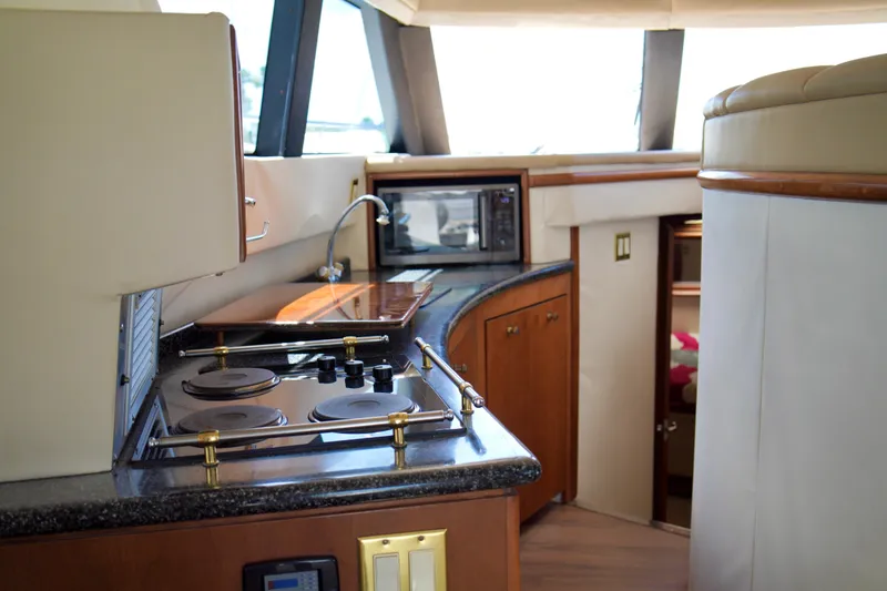 Slide: The Image of Interior of 1999 Carver 450 Voyager Pilothouse yacht with modern kitchen amenities. - 34