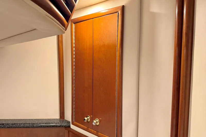 Slide: The Image of Wooden cabinet doors inside a 1999 Carver 450 Voyager Pilothouse yacht interior. - 40