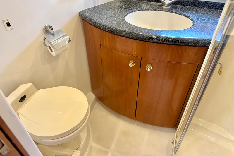 Slide: The Image of Bathroom interior of 1999 Carver 450 Voyager Pilothouse with toilet and sink. - 43