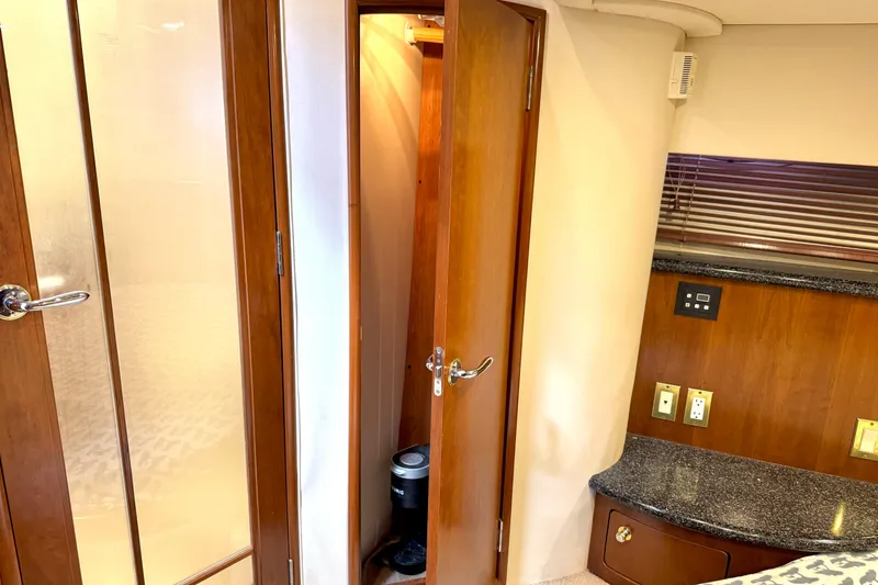 Slide: The Image of Interior of 1999 Carver 450 Voyager Pilothouse with wooden doors and granite countertop. - 48