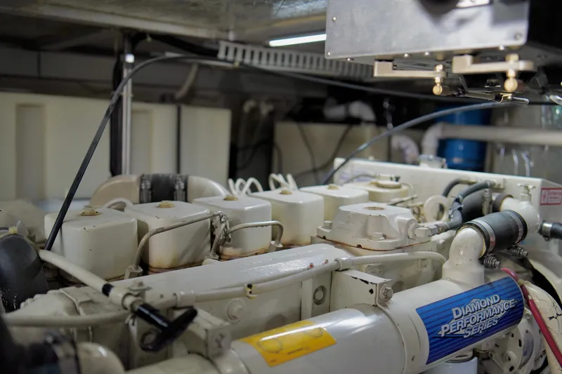Slide: The Image of Engine room of a 1999 Carver 450 Voyager Pilothouse yacht, showcasing machinery details. - 53