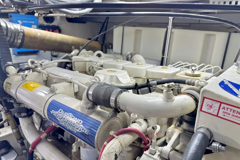 Slide: The Image of Engine room of a 1999 Carver 450 Voyager Pilothouse yacht, showcasing mechanical components. - 55