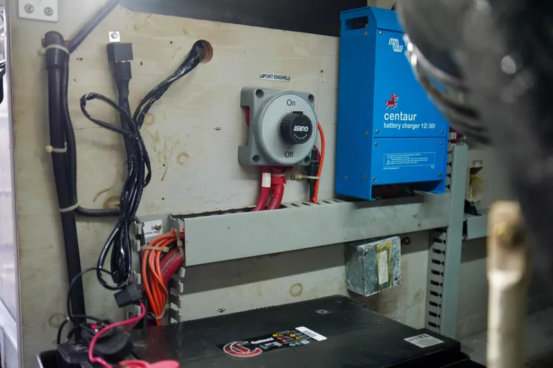 Slide: The Image of Electrical setup in a 1999 Carver 450 Voyager Pilothouse with battery charger and wiring. - 60