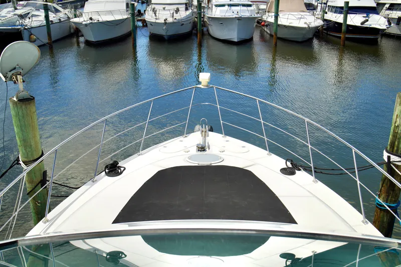 Slide: The Image of Bow view of a 1999 Carver 450 Voyager Pilothouse docked at a marina. - 7