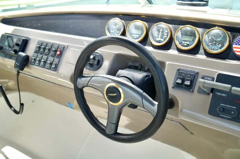 Slide: The Image of 1999 Carver 450 Voyager Pilothouse helm with steering wheel and instrument panel. - 72